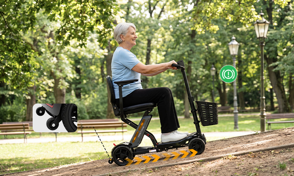 Senior woman riding the Meet One Glide mobility scooter on an outdoor park path with four-wheel stability support.
