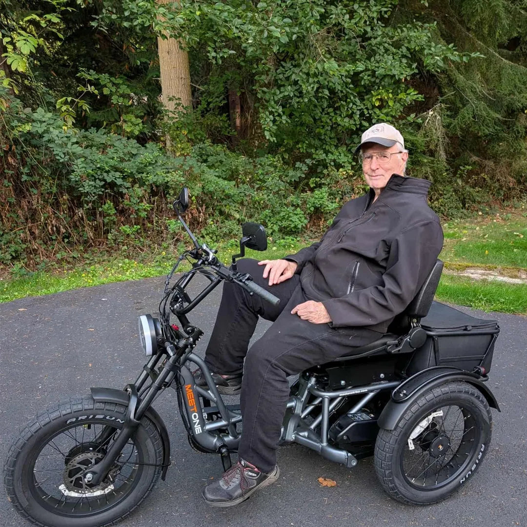 Rider using a semi-recumbent electric trike with back support for improved knee and hip comfort