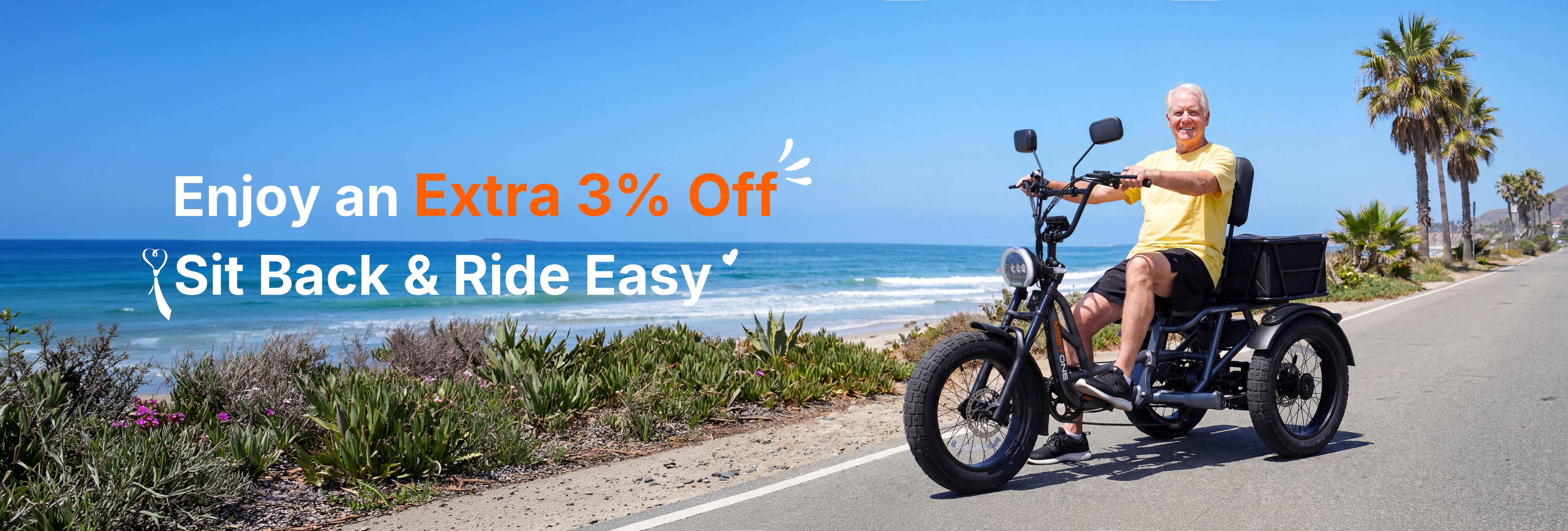 Man riding a Tour Lite 2.0 eTrike on a coastal road